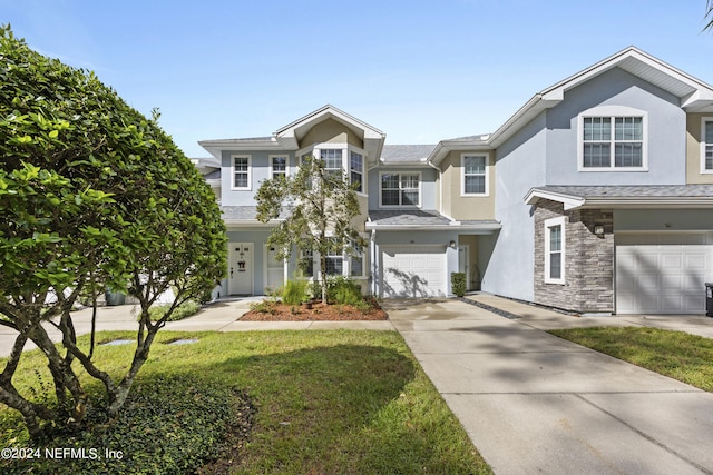 view of front of house with a front lawn and a garage