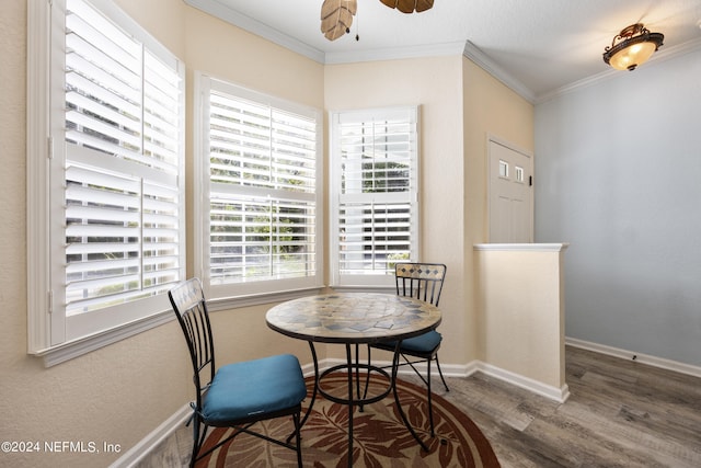 dining space with ornamental molding, dark hardwood / wood-style floors, and ceiling fan