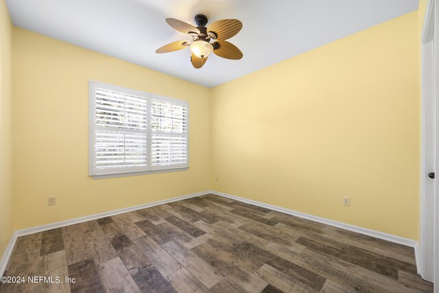 empty room featuring dark wood-type flooring and ceiling fan