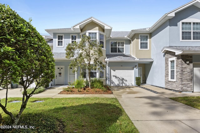 view of front of property with a front lawn and a garage