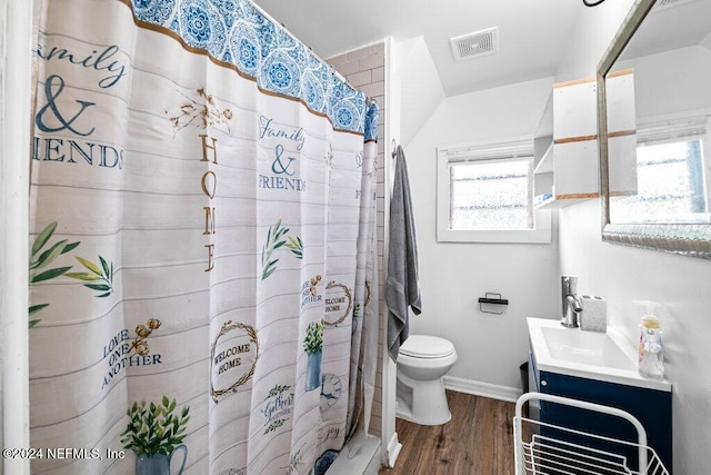 bathroom featuring vanity, curtained shower, hardwood / wood-style flooring, and toilet