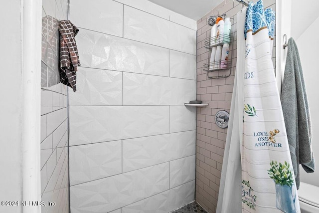 bathroom with toilet, a baseboard heating unit, and a shower with curtain