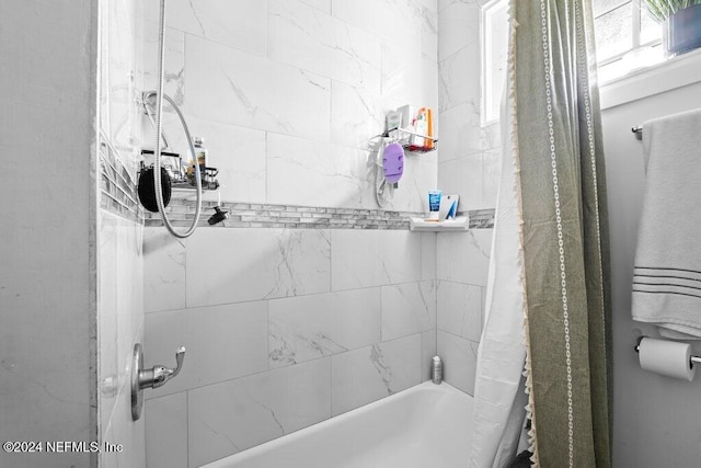 bathroom featuring shower / tub combo with curtain