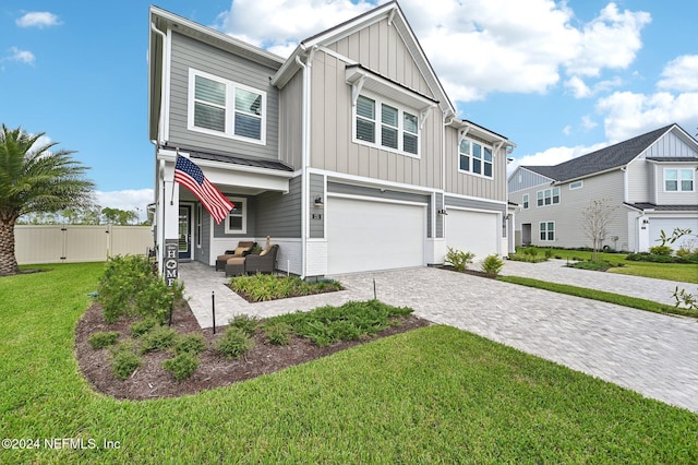 view of front of home featuring a garage and a front lawn