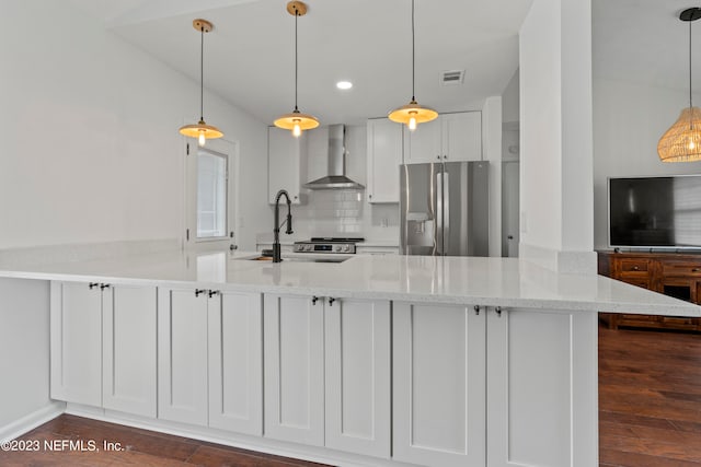 kitchen featuring wall chimney range hood, stainless steel fridge, decorative light fixtures, white cabinets, and dark hardwood / wood-style floors