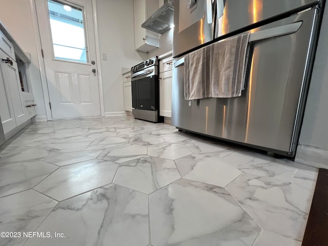 kitchen with appliances with stainless steel finishes, white cabinets, and extractor fan