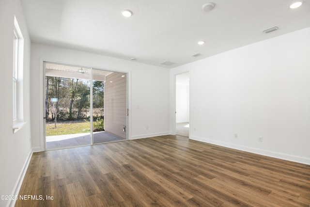 unfurnished room featuring dark hardwood / wood-style flooring