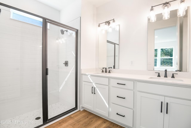 bathroom featuring vanity, an enclosed shower, and hardwood / wood-style flooring