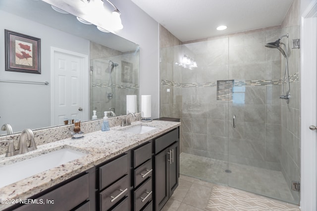 bathroom featuring vanity, tile patterned flooring, and an enclosed shower