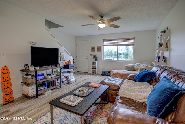 living room featuring hardwood / wood-style floors, a textured ceiling, and ceiling fan