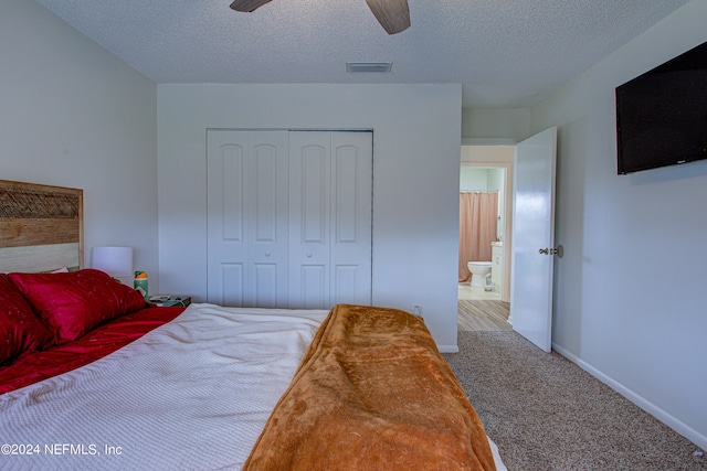 bedroom with a closet, a textured ceiling, carpet flooring, and ceiling fan