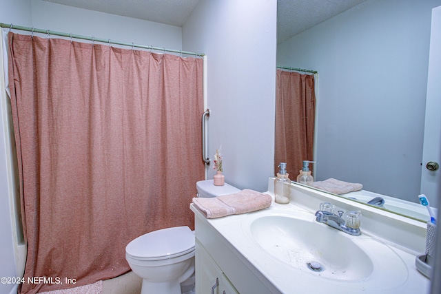 bathroom with toilet, a textured ceiling, a shower with curtain, and vanity