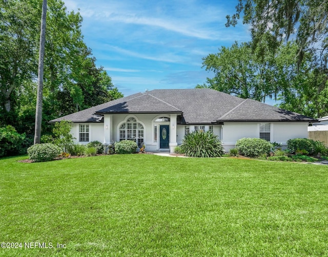 ranch-style home featuring a front yard