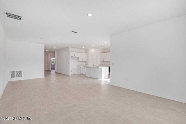 unfurnished living room with sink