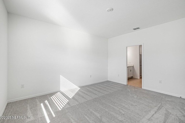 unfurnished room with light colored carpet