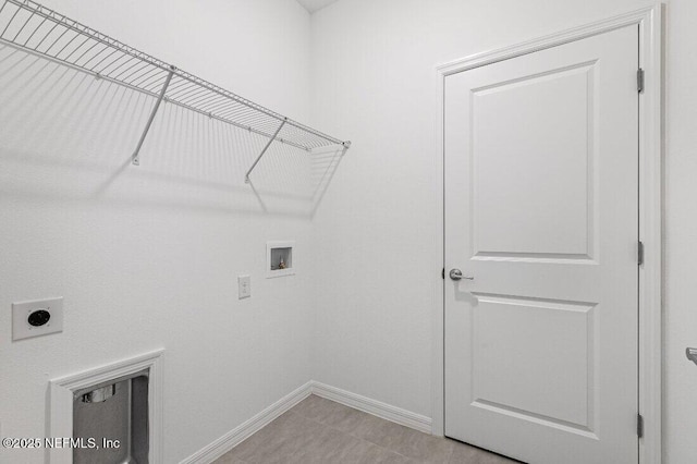 laundry area with light tile patterned flooring, hookup for a washing machine, and electric dryer hookup