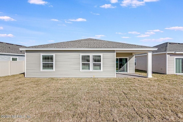 rear view of house with a yard and a patio area