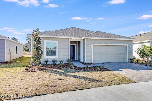 view of front of house featuring a garage and a front lawn