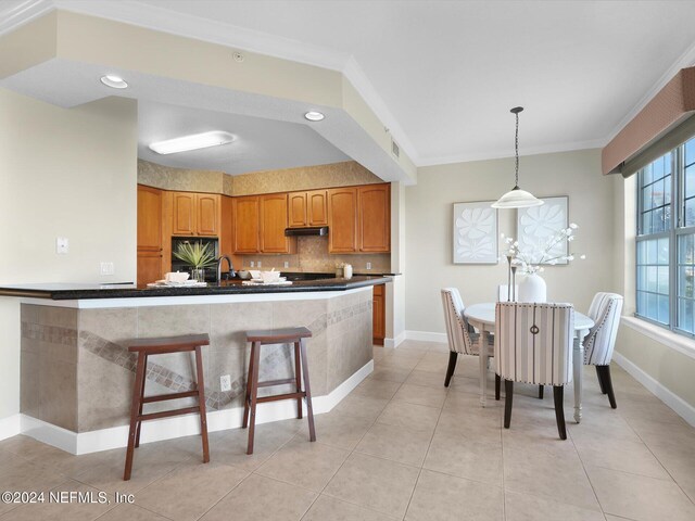 415 N Ocean Grande Dr Unit 102, Ponte Vedra Beach, FL 32082 - kitchen with crown molding, sink, hanging light fixtures, and light tile patterned floors