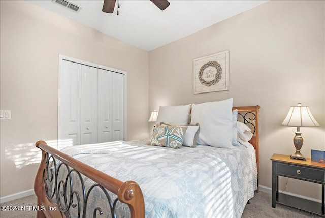 carpeted bedroom featuring ceiling fan and a closet