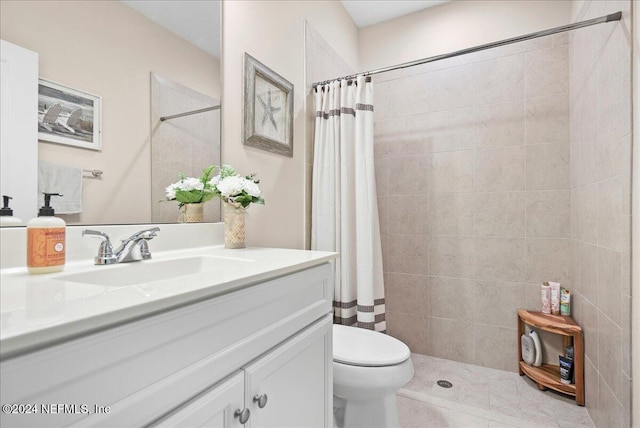 bathroom with vanity, toilet, and walk in shower