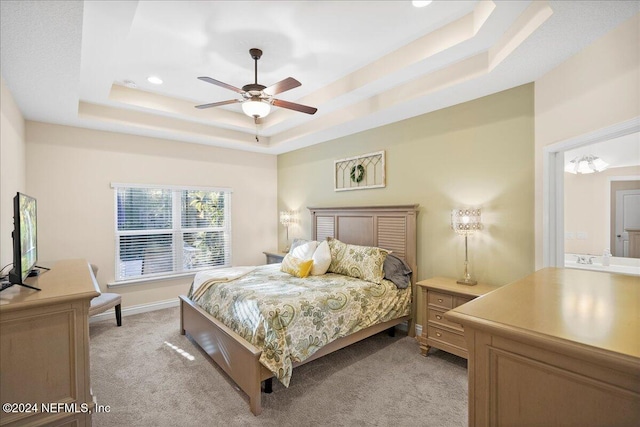 bedroom featuring a tray ceiling, ceiling fan, and light colored carpet