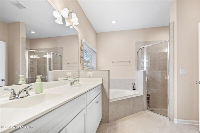 bathroom with plus walk in shower, vanity, and tile patterned floors