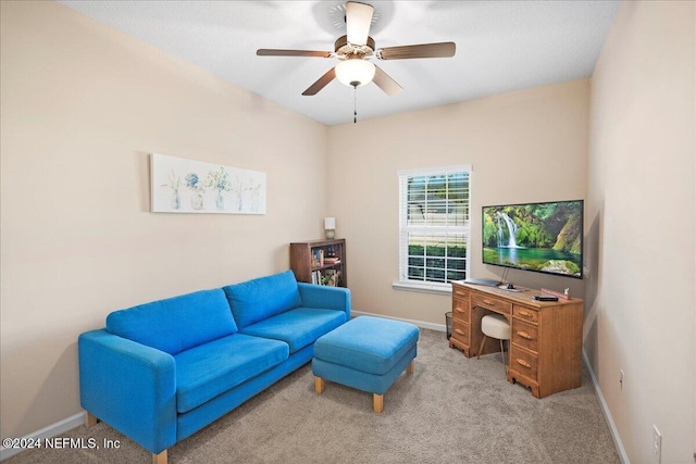 carpeted living room with ceiling fan