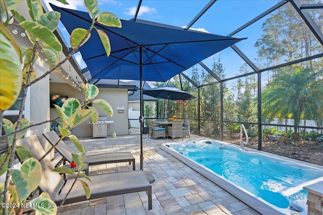 view of swimming pool with a patio and a lanai