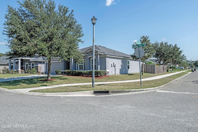 ranch-style house with a front yard and a garage