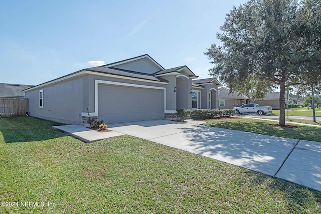 view of front of property featuring a garage and a front lawn