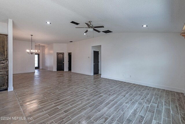 unfurnished living room with wood-type flooring, ceiling fan with notable chandelier, and a textured ceiling