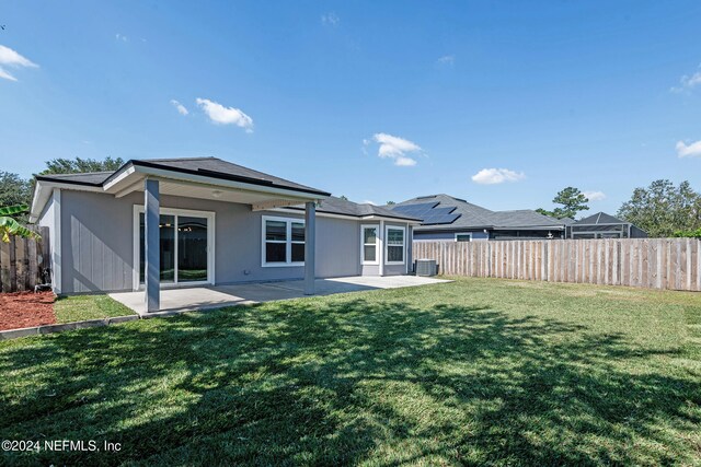 back of house featuring a patio, central AC, and a lawn