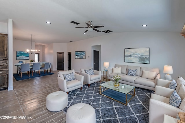 living room with ceiling fan with notable chandelier