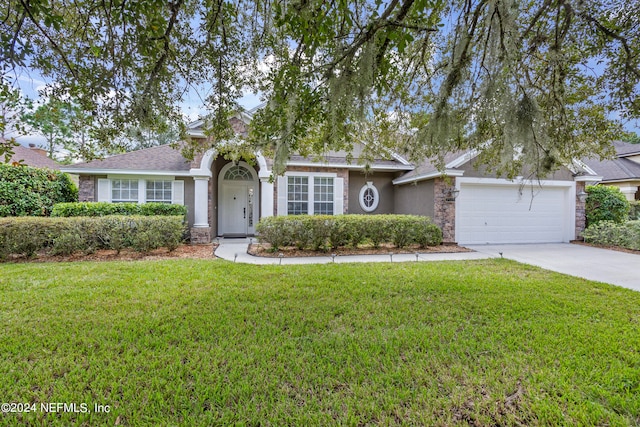 ranch-style home featuring a front lawn and a garage