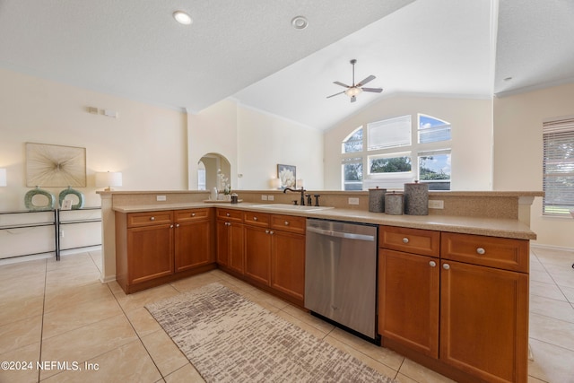 kitchen featuring stainless steel dishwasher, sink, vaulted ceiling, and a wealth of natural light