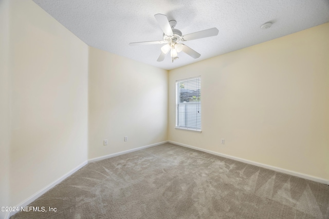 empty room featuring light carpet, a textured ceiling, and ceiling fan