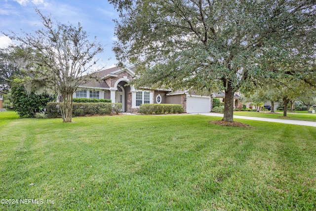 view of front facade with a front yard and a garage