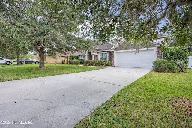 view of front of home featuring a front yard and a garage