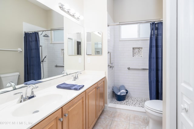 bathroom featuring a sink, a shower stall, toilet, and tile patterned floors