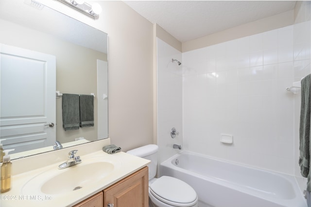 bathroom with shower / bathing tub combination, vanity, toilet, and a textured ceiling