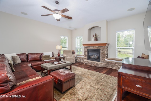 living room with ceiling fan, dark wood-style flooring, and a fireplace