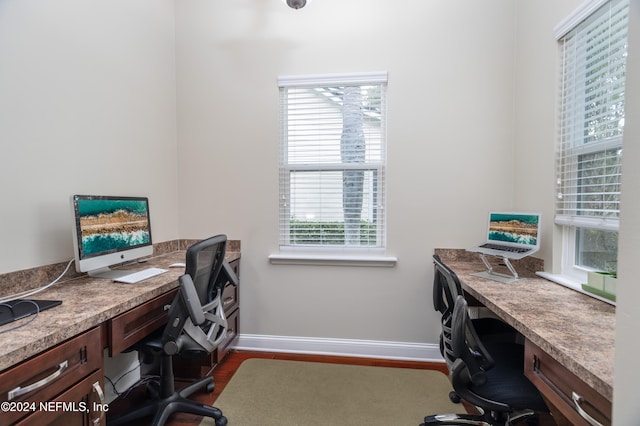 office featuring baseboards and dark wood finished floors