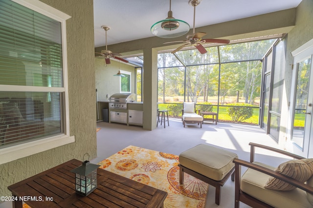 sunroom / solarium with a ceiling fan