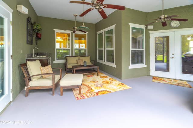 sunroom / solarium with french doors, a sink, and a ceiling fan