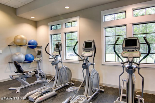 workout room with a healthy amount of sunlight, baseboards, and recessed lighting