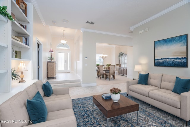 tiled living room with baseboards, visible vents, a chandelier, and crown molding