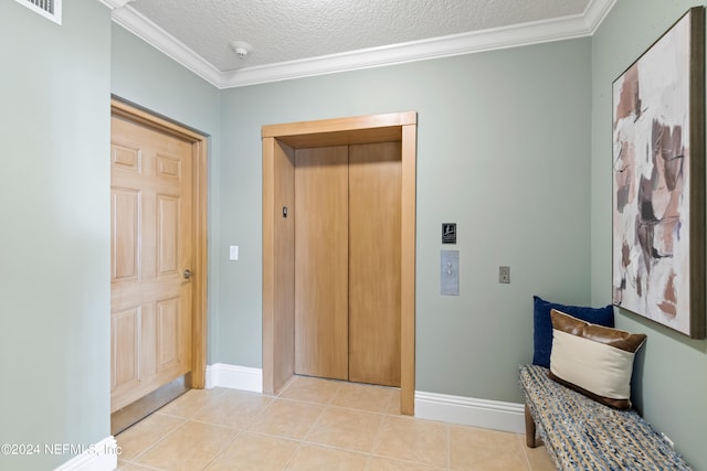 corridor with a textured ceiling, light tile patterned floors, elevator, and ornamental molding