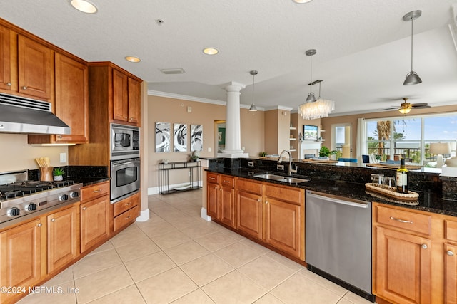 kitchen with sink, hanging light fixtures, stainless steel appliances, dark stone countertops, and ventilation hood