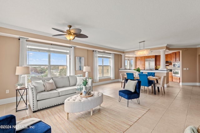 living room featuring crown molding, light tile patterned flooring, and ceiling fan